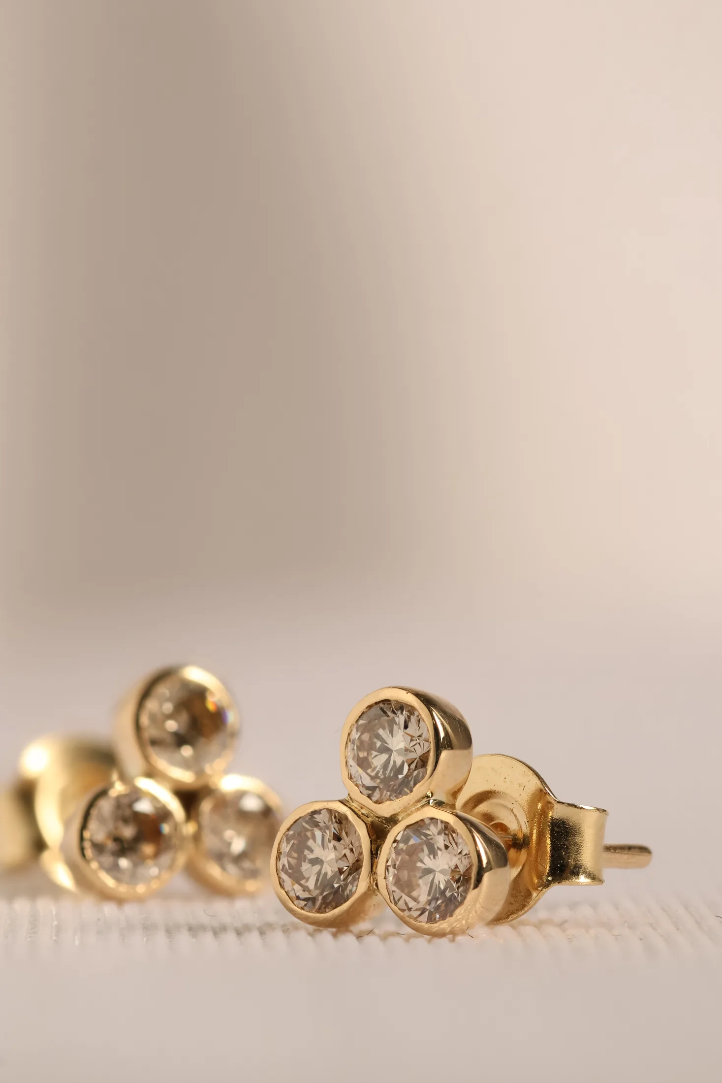 Hand-finished gold settings on diamond stud earrings