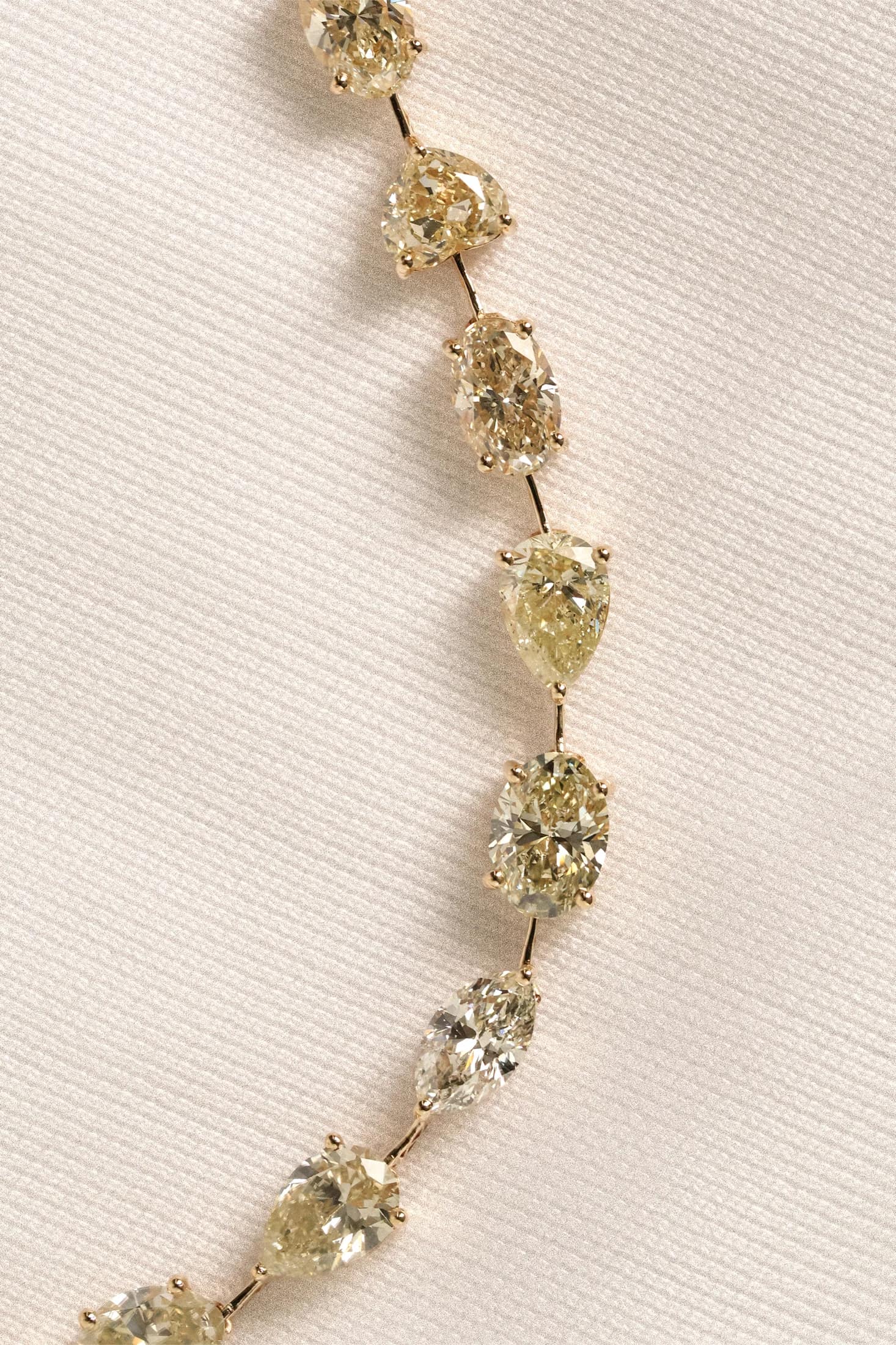 Yellow diamond bracelet on pale fabric